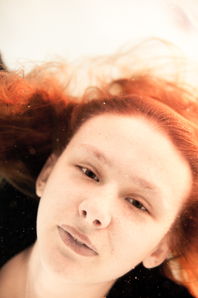 Girl with red hair underwater