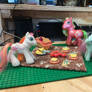 Applejack and two kids having a picnic.