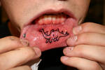 dino lip tattoo
