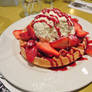 Waffle with strawberries and iced cream