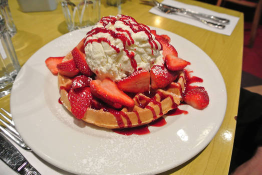 Waffle with strawberries and iced cream