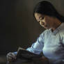 Asian Woman In a Kimono Reading a Book