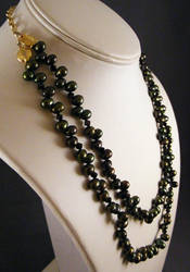 Two Strand Necklace of Offset Green Oval Peals