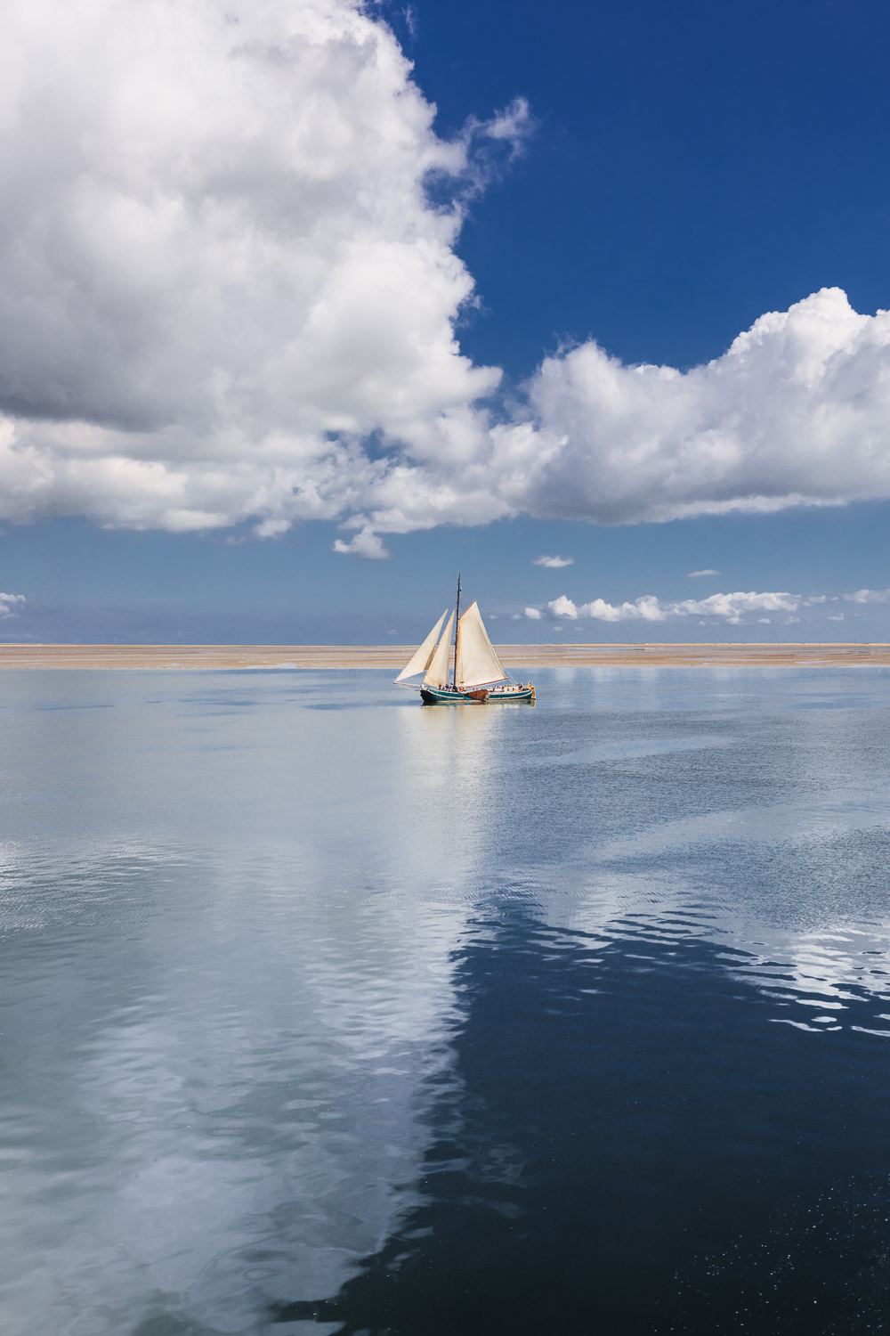 sailing boat between clouds