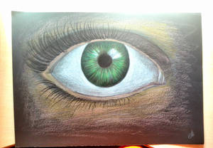 Green eye in black paper