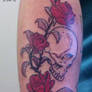 Skull and flowers tattoo