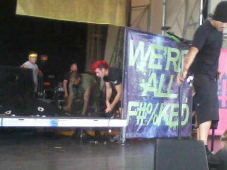 Brian behind the We're All F#%cked sign xD