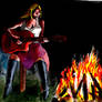 Tara playing guitar at campfire