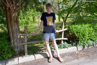 Beautiful young boy in shorts at nature