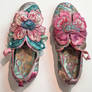 Now Two Pairs Of Shoes With A Pink And Blue Flower