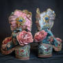 Now Two Pairs Of Shoes With A Pink And Blue Flower