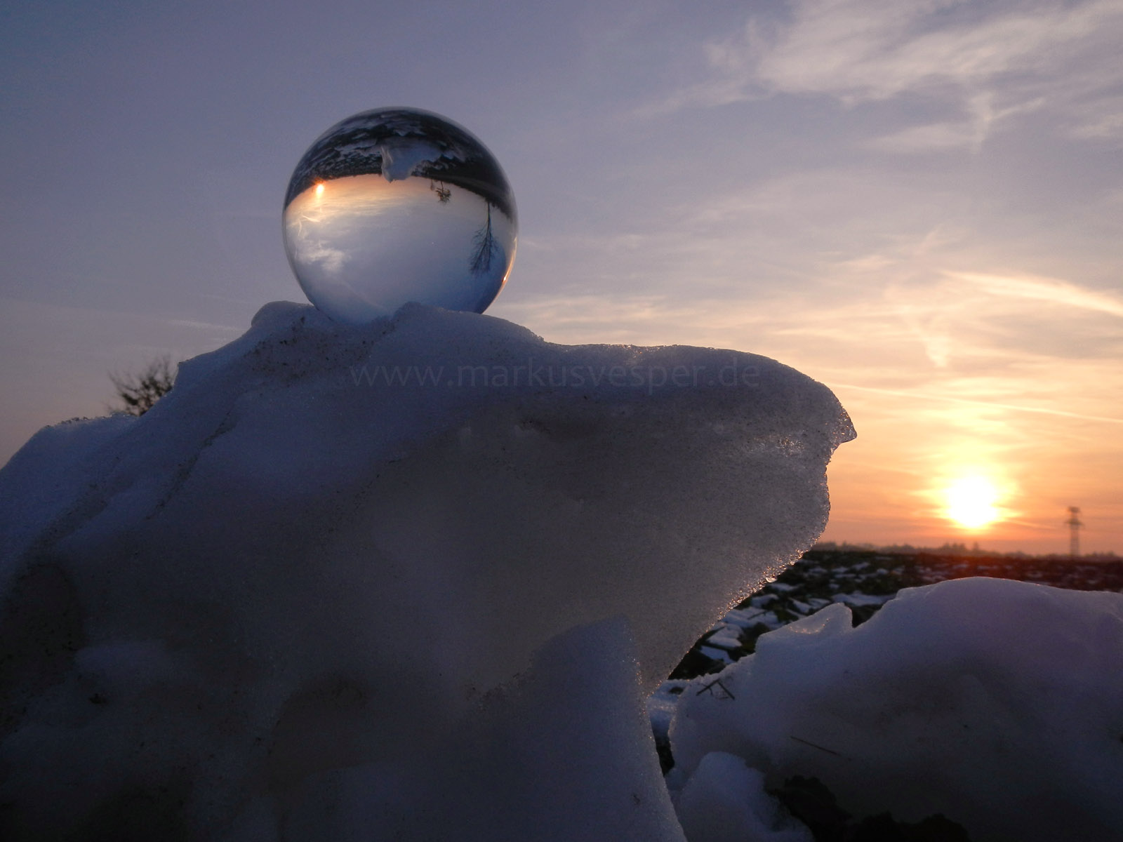 Crystaline sphere on snow pile at sunset 2