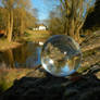 Glass sphere on rock at a pond