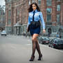 Pretty brunette policewoman wearing a dark blue sh