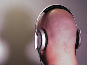 Bald man wearing Headphones 3