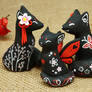 Black Oriental Foxes and a Cat