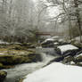 Snow stream rock foot-bridge stock