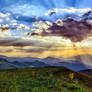 Mountains and sun covered by clouds