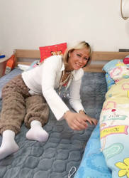 Agnetha making the bed with limp legs