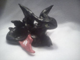 Toothless clay figurine