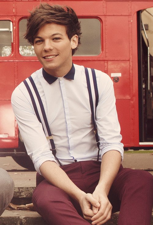 Louis sitting on the stairs with a smile