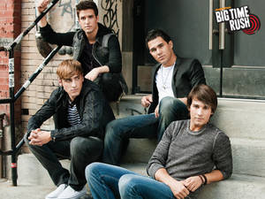Big Time Rush sitting on the stairs