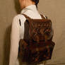A leather backpack with copper ornament