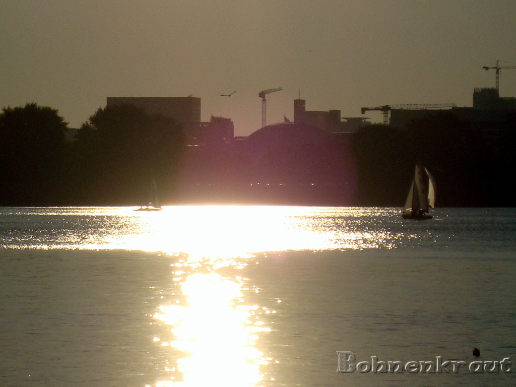 Reflection of the sun with sailing boat