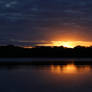 Lake Reflecting Golden Sunrise, Trees Dark Clouds