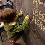 Toddler at a Chalkboard