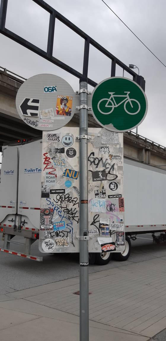 Stickered Street Sign by Onisym on DeviantArt