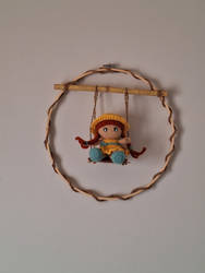 Wall art swinging doll