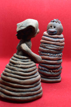 Ceramic statuette of a peasant woman and an Africa