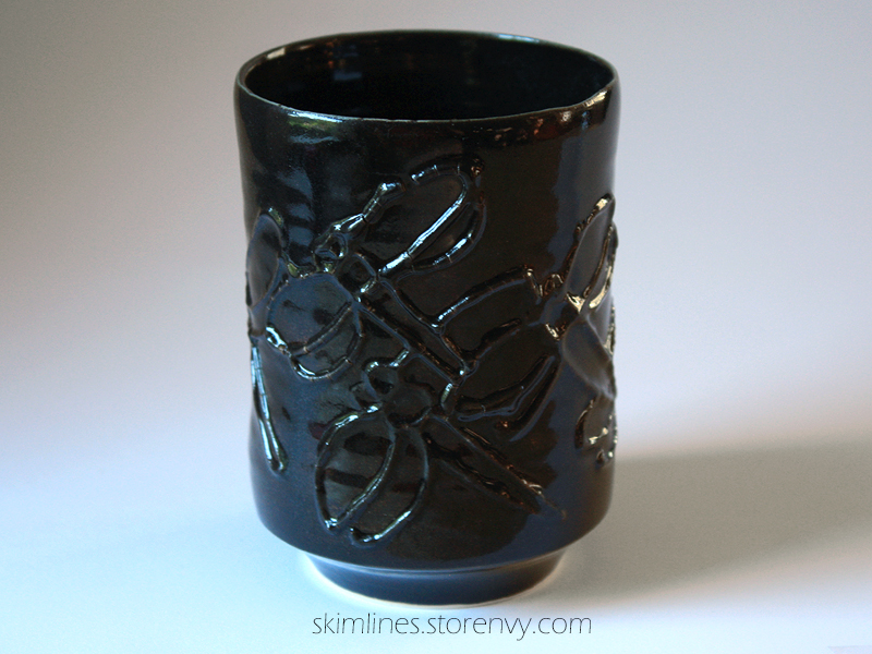 Dragonflies in black tea cup