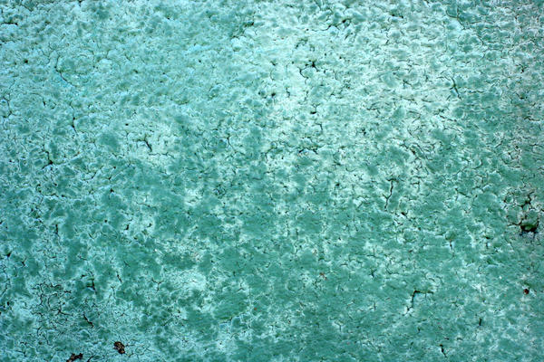 Faded Green Paint on Concrete