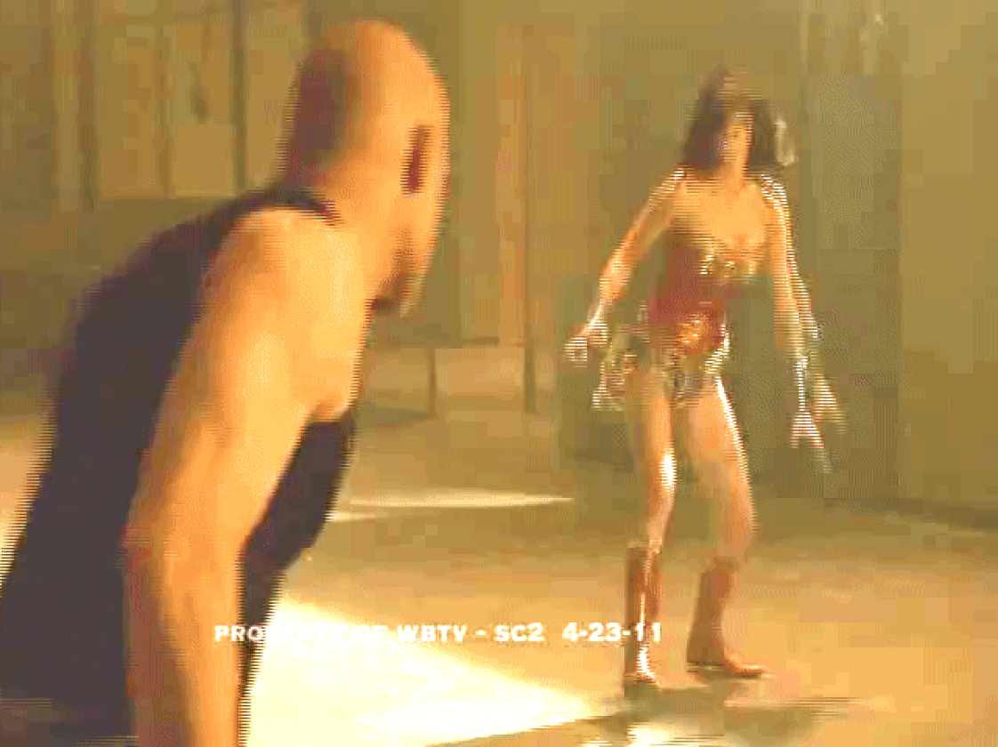 Wonder Woman punching a thug with style
