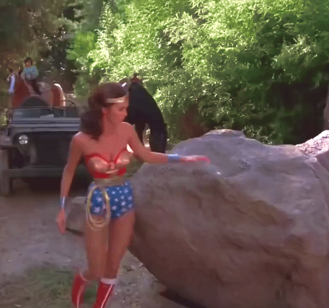 Wonder Woman easily moving a giant boulder