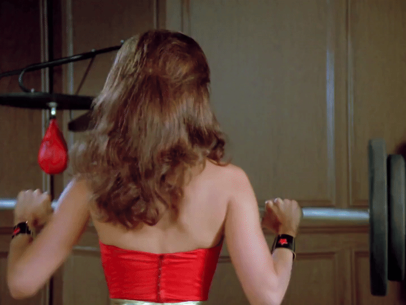 Wonder Woman lifting weights and tossing her tiara