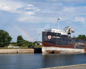 Rainbow accompanying a Docked Boat