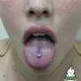 Fresh tongue piercing with titanium and white gem