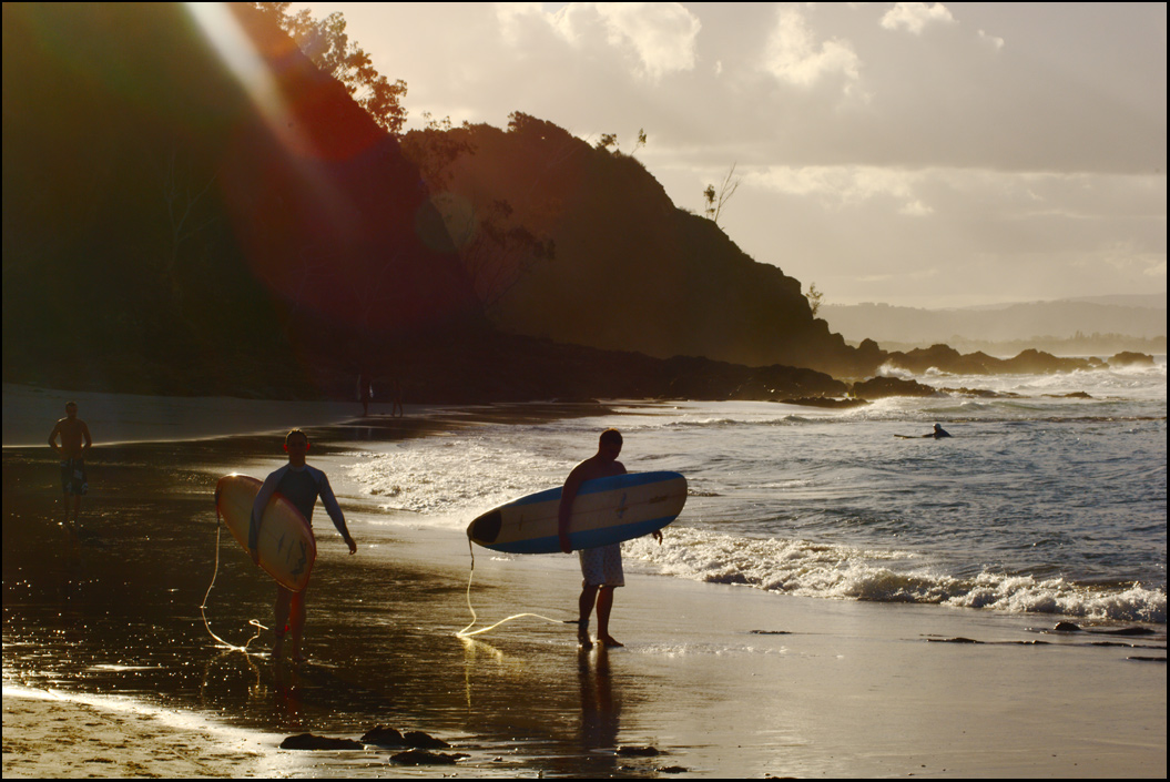 Surfers in shard of light