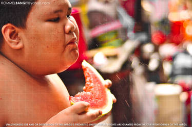 Flabby Boy eating large Juicy Red Watermelon