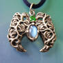 Leaf and vine pendant with moonstone and emerald.