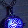 Glowing triskelion necklace blue glowing orb
