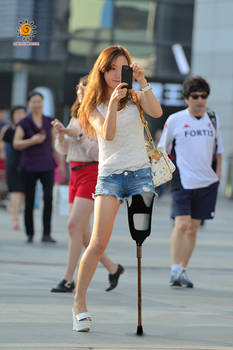 A Lak girl with pegleg taking photos