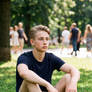 Young Male - Sitting on Ground in a Park