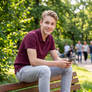 Young Male - Sitting on a Bench in a Park - Candid Shot