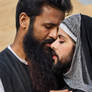 Muslim woman in beard kissing a man
