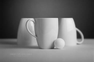 Three cups with a ball