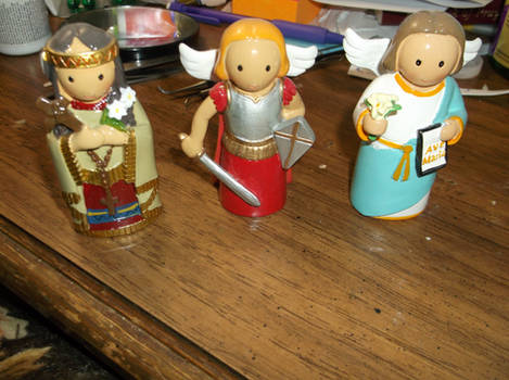 Saints Kateri, Michael, and Gabriel figures